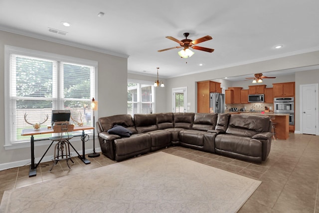 living area with ornamental molding, visible vents, baseboards, and light tile patterned flooring