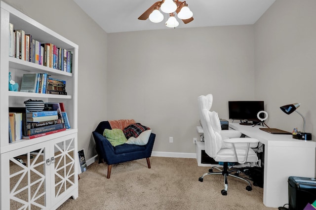 home office featuring carpet, ceiling fan, and baseboards