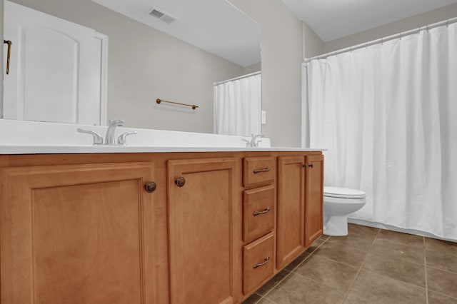 full bathroom with double vanity, visible vents, toilet, a sink, and tile patterned flooring