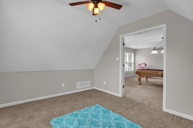 additional living space featuring vaulted ceiling, carpet flooring, visible vents, and baseboards