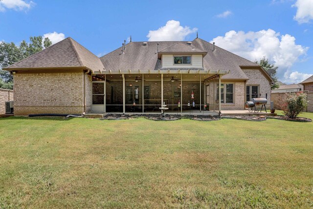 back of property featuring a yard, brick siding, and a patio area