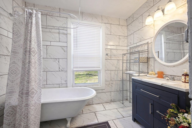 bathroom featuring a shower with shower curtain, vanity, tile walls, a freestanding bath, and marble finish floor