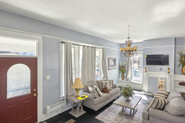 living room with an inviting chandelier, plenty of natural light, and a textured ceiling