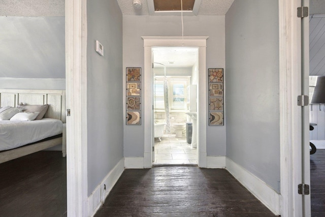 entrance foyer featuring dark wood finished floors and baseboards