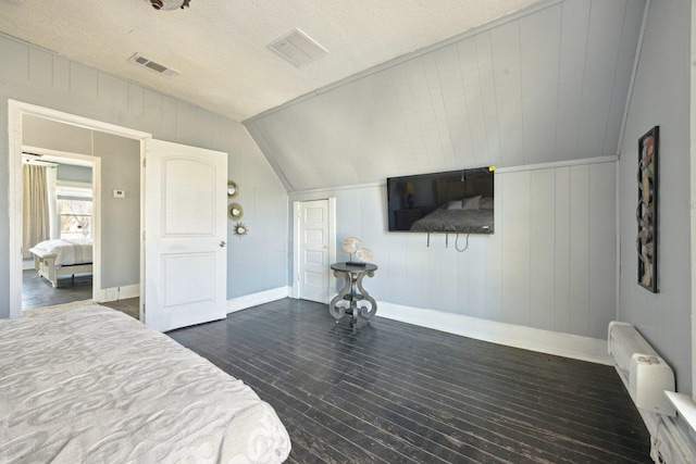 bedroom with lofted ceiling, baseboards, visible vents, and dark wood-style flooring