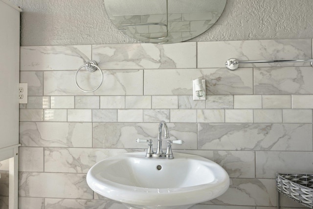 bathroom with a sink and a textured wall