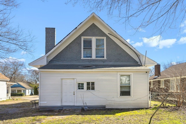 back of property featuring a chimney