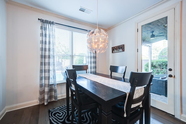 dining area with crown molding, dark wood finished floors, visible vents, a chandelier, and baseboards