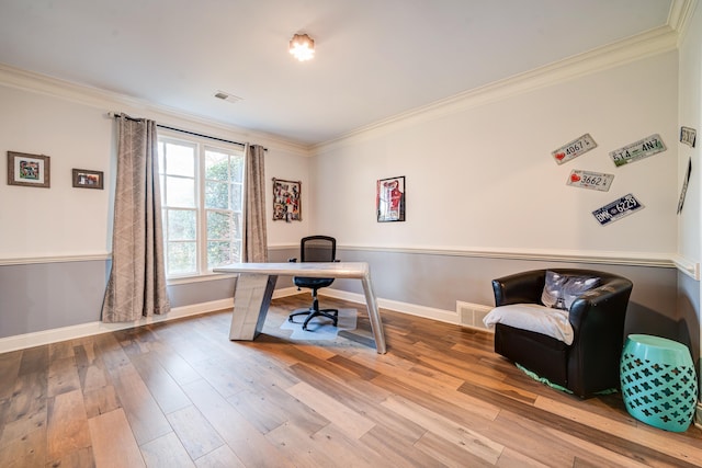 home office with crown molding, visible vents, and wood finished floors