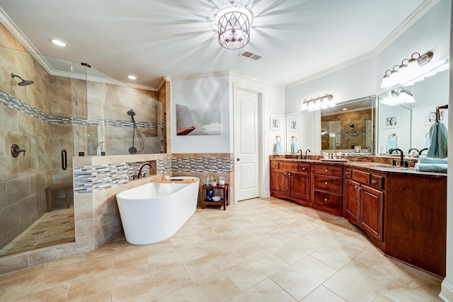 full bath featuring double vanity, ornamental molding, a sink, a shower stall, and a freestanding tub