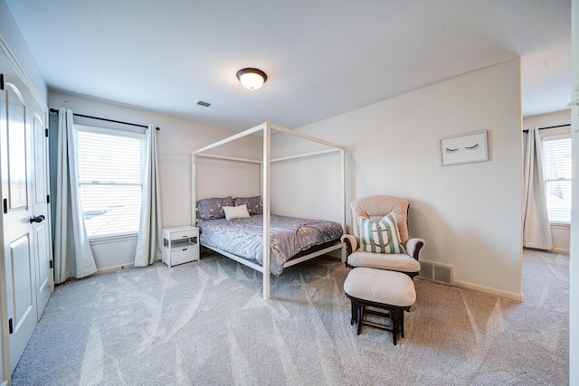 bedroom with baseboards, visible vents, and carpet flooring