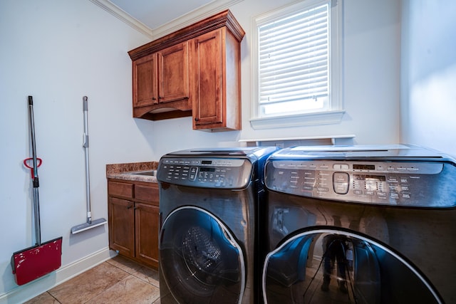 laundry room with cabinet space, baseboards, independent washer and dryer, crown molding, and light tile patterned flooring