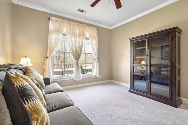 living area with ceiling fan, visible vents, baseboards, ornamental molding, and carpet