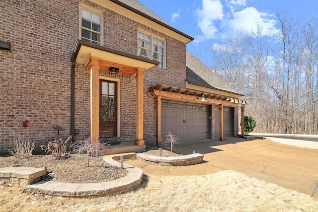 view of front of house with brick siding, driveway, and roof with shingles