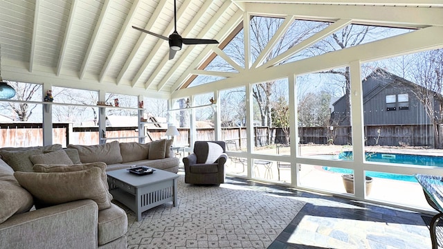 sunroom with vaulted ceiling with beams, ceiling fan, and a wealth of natural light