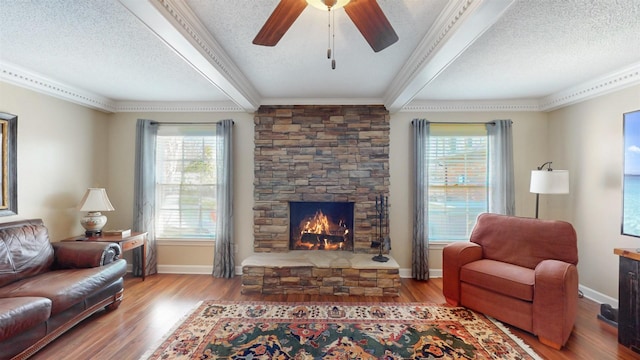 living room featuring a healthy amount of sunlight, a textured ceiling, and wood finished floors