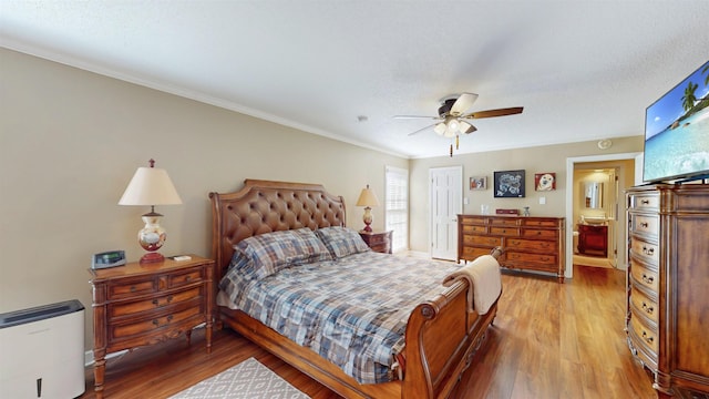 bedroom with baseboards, crown molding, light wood finished floors, and ceiling fan