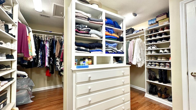 walk in closet featuring wood finished floors and visible vents