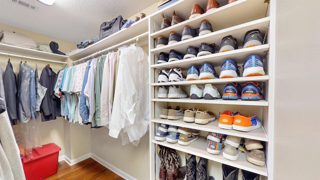 walk in closet featuring visible vents and wood finished floors