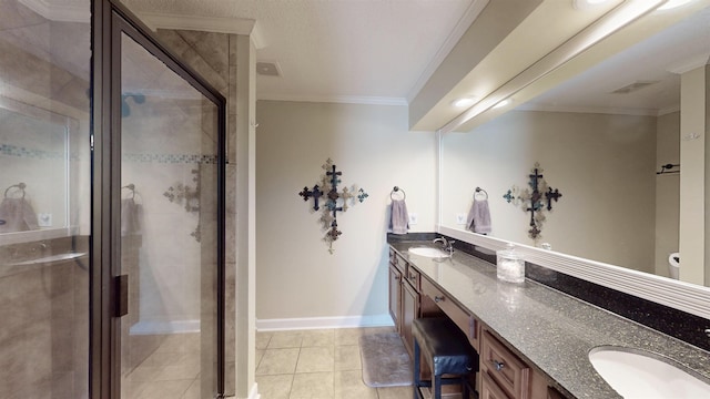 bathroom with ornamental molding, a sink, a shower stall, and double vanity