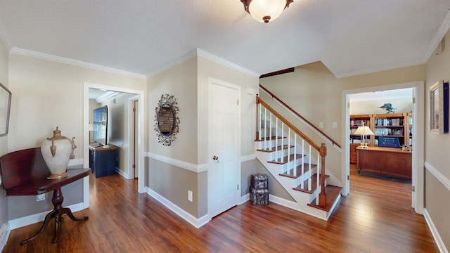 interior space featuring ornamental molding, wood finished floors, and baseboards