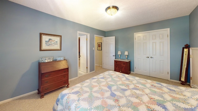 bedroom featuring a closet, light colored carpet, and baseboards