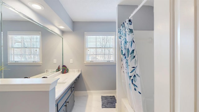 full bathroom featuring curtained shower, vanity, and baseboards