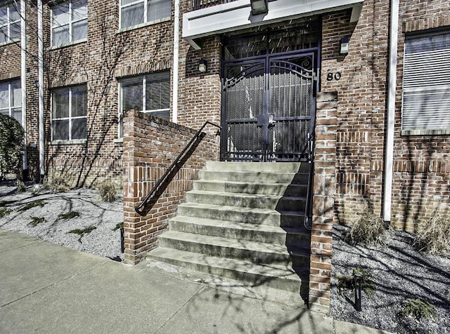 entrance to property featuring brick siding