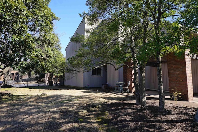 view of side of property featuring fence