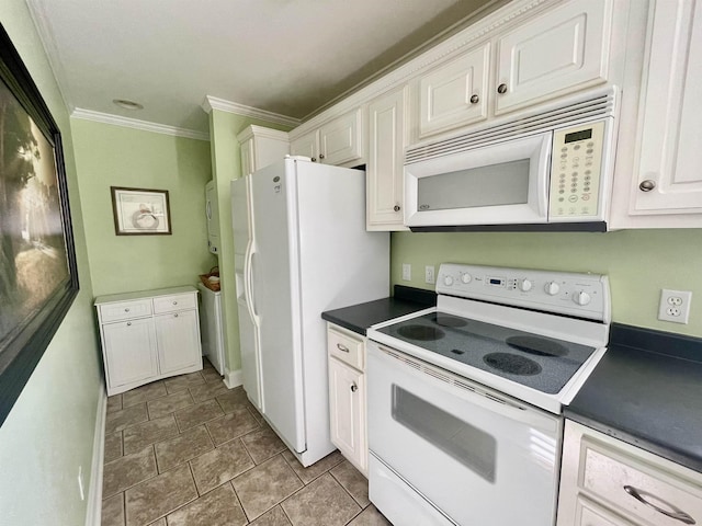 kitchen with dark countertops, white appliances, white cabinets, and crown molding