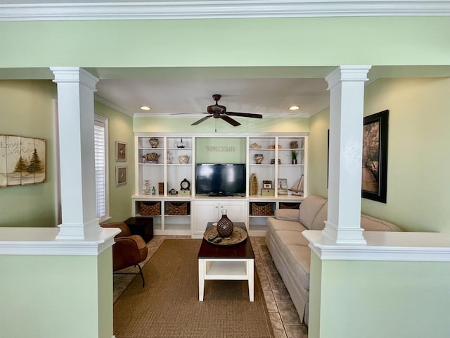 living room with a ceiling fan, crown molding, and ornate columns