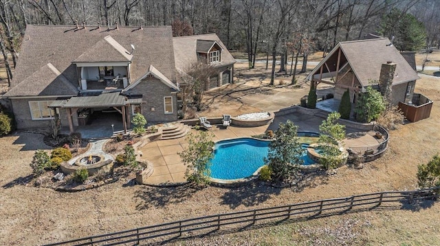 view of pool with a fire pit, a patio area, and a fenced backyard