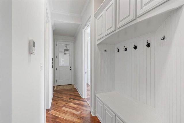 mudroom featuring ornamental molding, light wood-style flooring, and baseboards