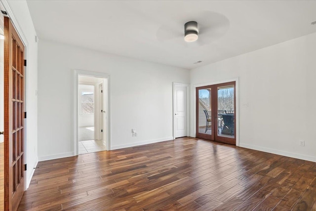 spare room featuring a ceiling fan, french doors, baseboards, and hardwood / wood-style floors