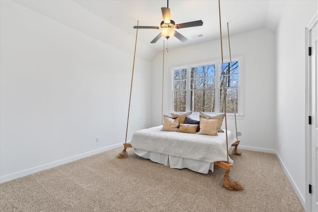 carpeted bedroom featuring ceiling fan, baseboards, visible vents, and vaulted ceiling