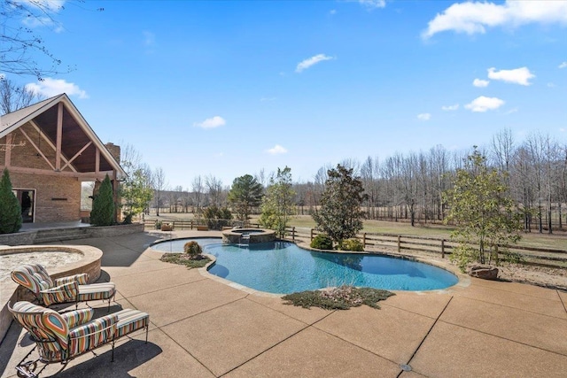 view of swimming pool featuring a pool with connected hot tub, fence, and a patio