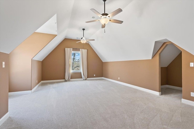 additional living space featuring lofted ceiling, ceiling fan, carpet flooring, and baseboards