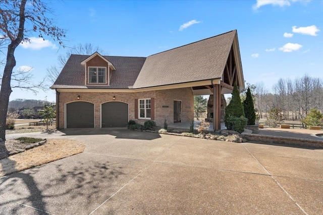 view of front of property featuring an attached garage, driveway, brick siding, and a shingled roof