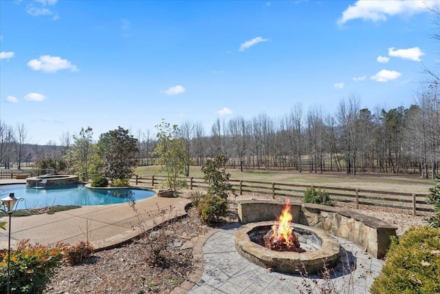 view of swimming pool featuring a patio, an outdoor fire pit, and fence