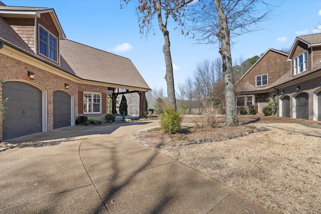 view of yard featuring a garage and driveway