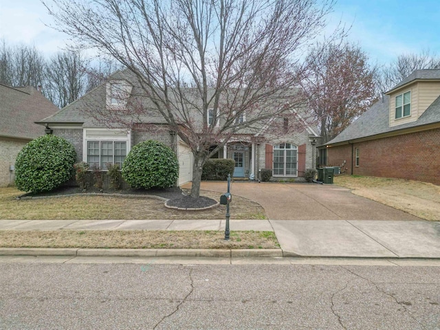 view of front of property featuring brick siding and driveway