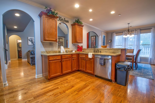 kitchen with dishwasher, a sink, light wood-style flooring, and brown cabinets