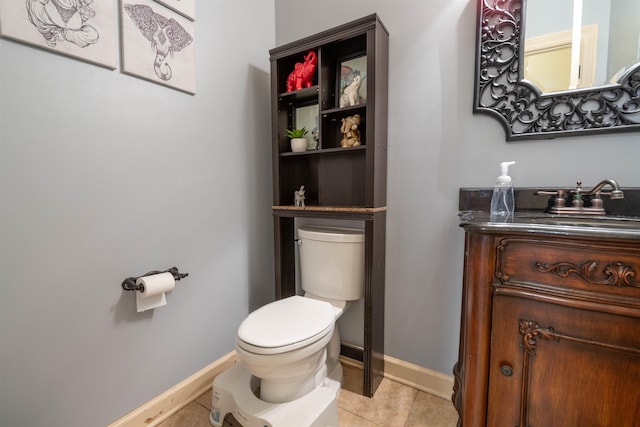 half bath with baseboards, vanity, toilet, and tile patterned floors