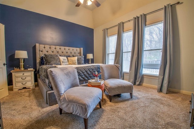 bedroom with a ceiling fan, carpet, lofted ceiling, and baseboards