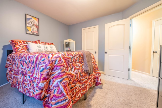 carpeted bedroom featuring baseboards