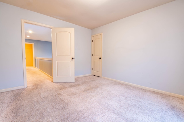 unfurnished room featuring carpet and baseboards