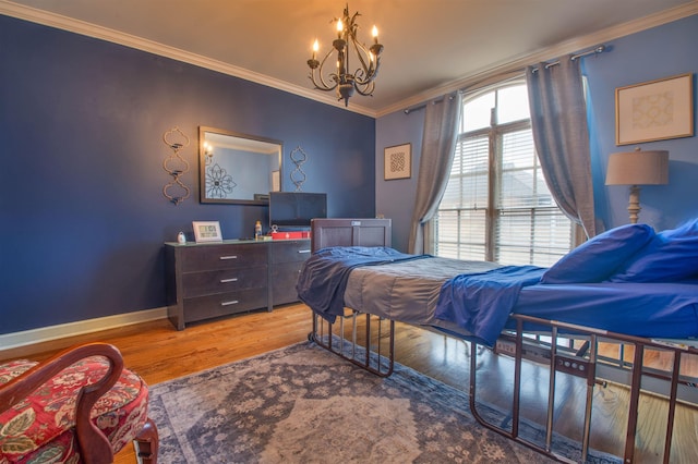 bedroom featuring baseboards, ornamental molding, and wood finished floors