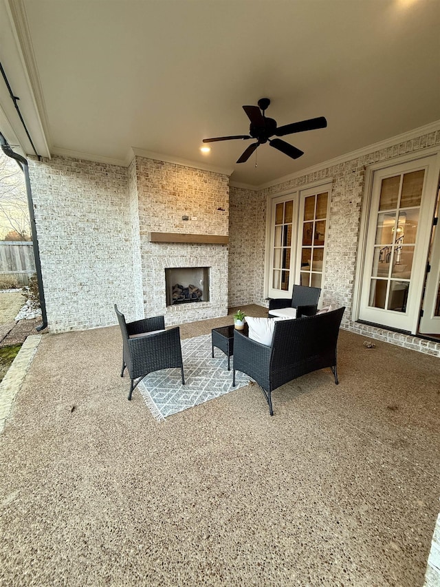 view of patio / terrace featuring a ceiling fan and an outdoor living space with a fireplace