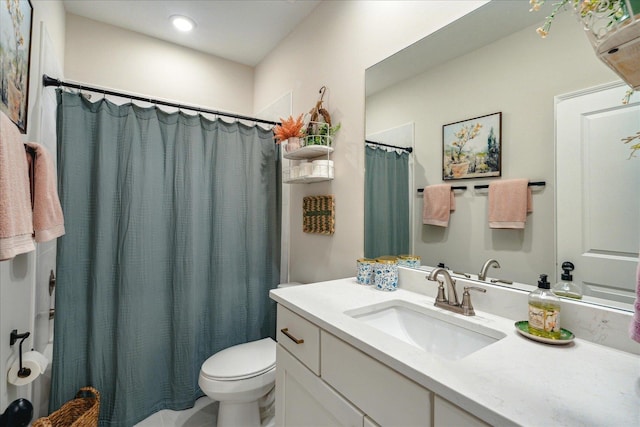 bathroom featuring vanity, toilet, and a shower with curtain