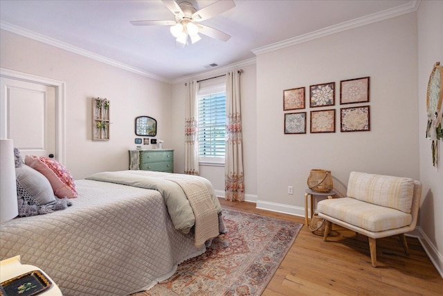 bedroom featuring ornamental molding, visible vents, light wood-style flooring, and baseboards